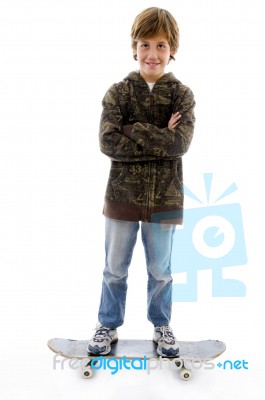 Front View Of Smiling Boy Standing On Skate Stock Photo