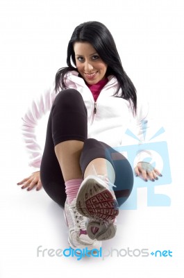 Front View Of Smiling Exercising Female On White Background Stock Photo