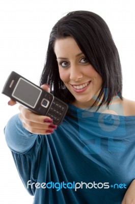 Front View Of Smiling Female Showing Mobile On White Background Stock Photo