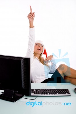 Front View Of Smiling Manager With Christmas Hat Pointing Up Stock Photo