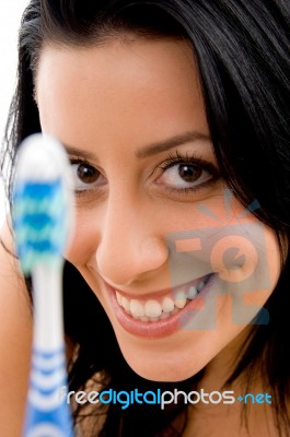 Front View Of Smiling Woman With Toothbrush On White Background Stock Photo