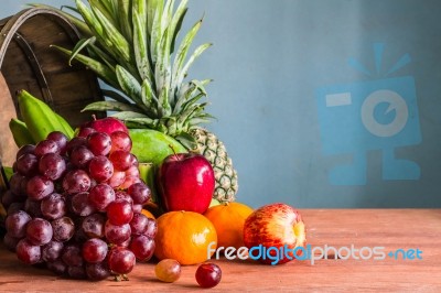 Fruits In Basket On A Wooden Stock Photo