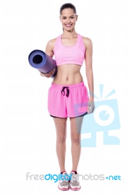 Full Length Pose Of Trainer With Exercise Mat Stock Photo