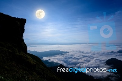 Full Moon On The Peak Mountain Stock Photo