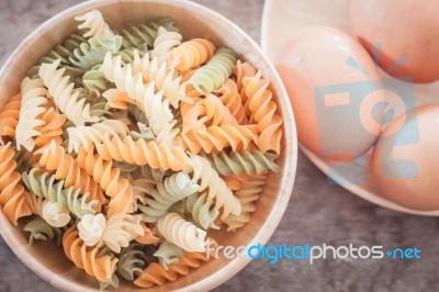 Fusili Pasta In Wooden Plate With Eggs Stock Photo
