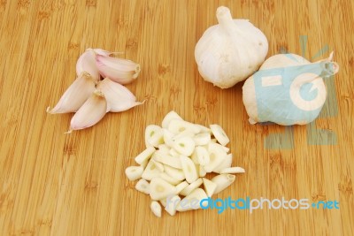 Garlic Preparation Ways On A Cutting Board Stock Photo