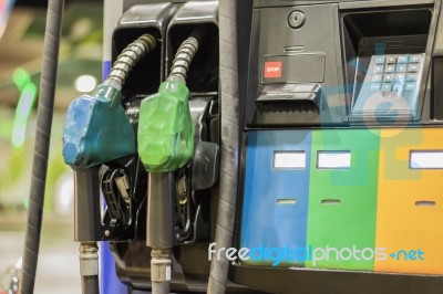 Gas Pump Nozzles In A Service Station Stock Photo