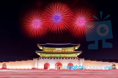 Geyongbokgung Palace At Night With Firework And Car Light In Seoul, South Korea Stock Photo