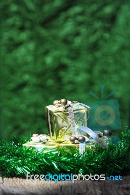 Gift Box On Old Wooden With Green Bokeh Background Stock Photo