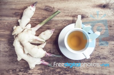 Ginger Tea In A White Cup On Wooden Background Stock Photo