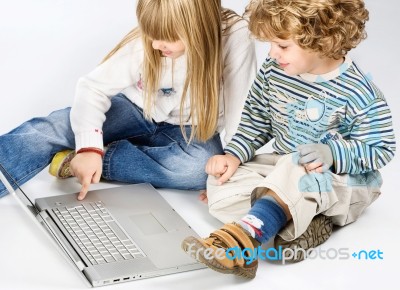 Girl And Boy Near Laptop Stock Photo