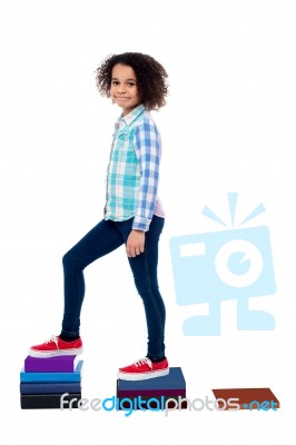 Girl Child Taking Steps Ahead Made From Notebooks Stock Photo