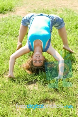 Girl Doing Gymnastic On Grass Stock Photo