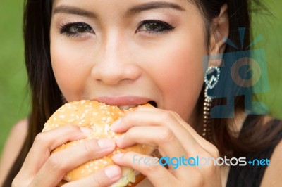Girl Eating A Cheeseburger Stock Photo