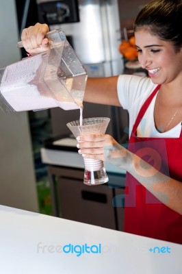 Girl Filling Glass With Strawberry Shake Stock Photo