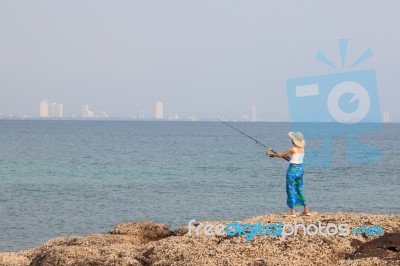 Girl Fishing On Beach Stock Photo