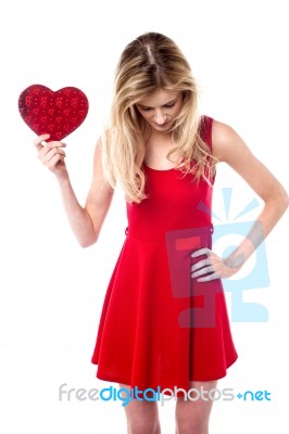 Girl Holding Valentine Gift Looking Down Stock Photo