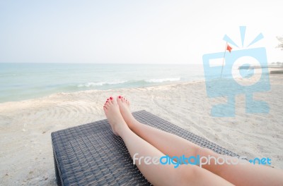 Girl Leg Lay On Sunbed At Beach Stock Photo