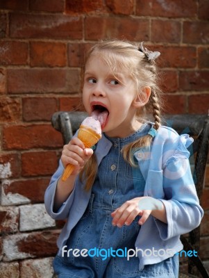 Girl Licking An Ice Cream Stock Photo