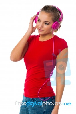 Girl Listening To Music Through Headphones Stock Photo
