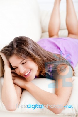Girl Lying On Sofa Stock Photo