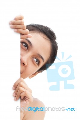 Girl Peeping From Behind Sign Stock Photo
