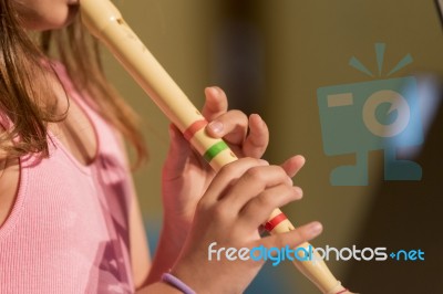 Girl Plays Flute Stock Photo