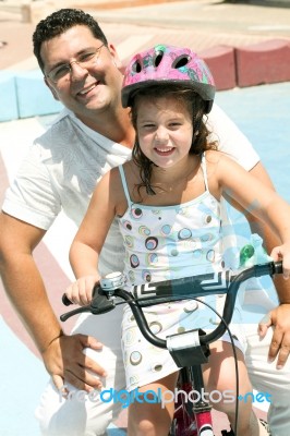 Girl Riding Bicycle Stock Photo