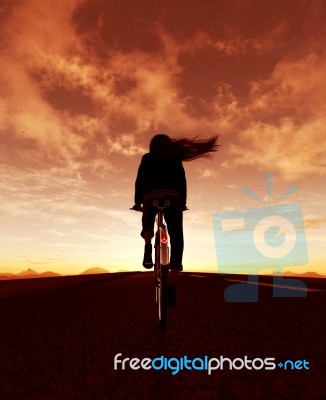 Girl Riding Bicycle In Street Outdoors At Sunrise Or Sunset Stock Image