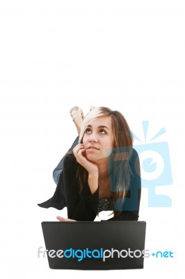 Girl Thinking And Lying With Laptop Stock Photo