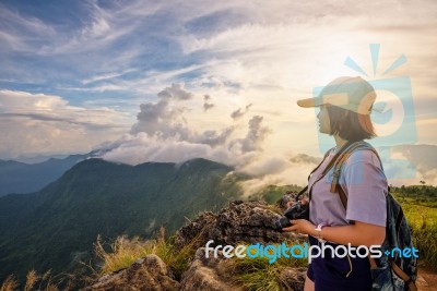 Girl Tourist On Mountains At Sunset Stock Photo