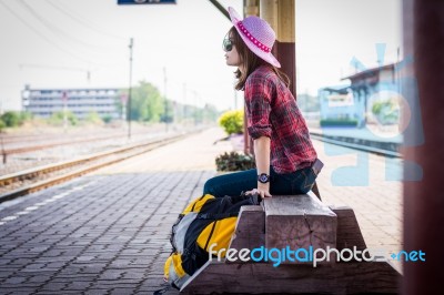 Girl Tourist Sitting On A Bench In A Train Station Stock Photo