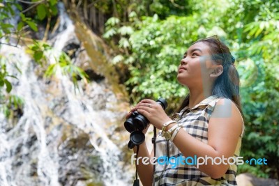 Girl Using Binoculars In Forest Stock Photo