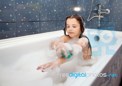 Girl Washing Her Hand Sitting In The Bath Stock Photo