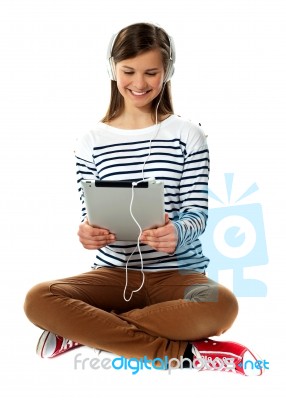 Girl Watching Video On Her Tablet Stock Photo