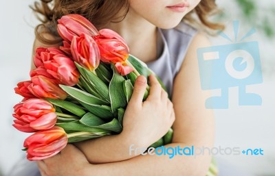 Girl With A Bouquet Of Tulips Stock Photo
