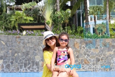 Girl With Her Mother Outside Swimming Pool Enjoying The Summerwi… Stock Photo