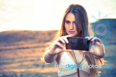 Girl With Smart Phone Near Beach Stock Photo