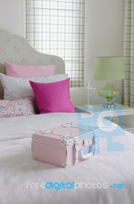 Girl's Bedroom With Pink Box On Green Bed Stock Photo