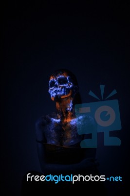 Girl's Face Painted Uv Skull Stock Photo