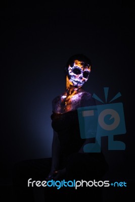 Girl's Face Painted Uv Skull Stock Photo