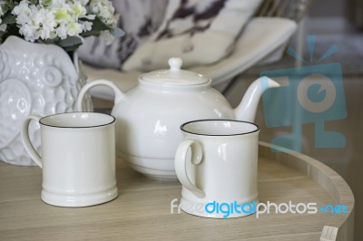 Glass And Kettles Is Made From Ceramic Tile On A Wooden Table Stock Photo