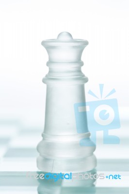 Glass Chess Queen Is Standing On Board, Cut Out From White Backg… Stock Photo