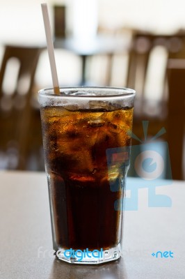 Glass Of Cola With Ice On A Table Stock Photo