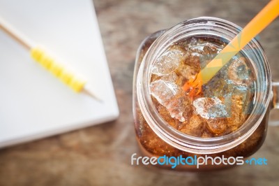 Glass Of Cola With Ice On Wooden Table Stock Photo