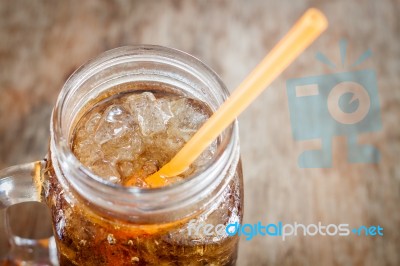 Glass Of Cola With Ice On Wooden Table Stock Photo
