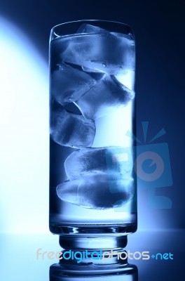 Glass Of Water Spot Light Blue With Ice Stock Photo