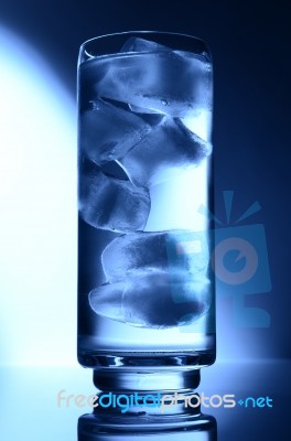 Glass Of Water Spot Light Blue With Ice Stock Photo