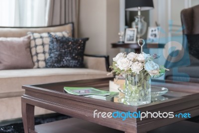 Glass Vase Of Flower On Wooden Table In Living Room Stock Photo
