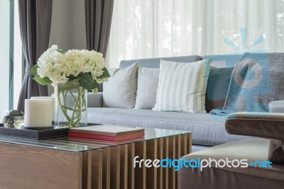 Glass Vase Of Plant On Wooden Table In Living Room Stock Photo
